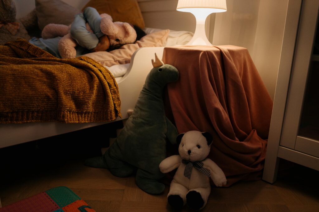A warm and cozy child's bedroom setting with plush toys and soft lighting creating a peaceful ambiance.